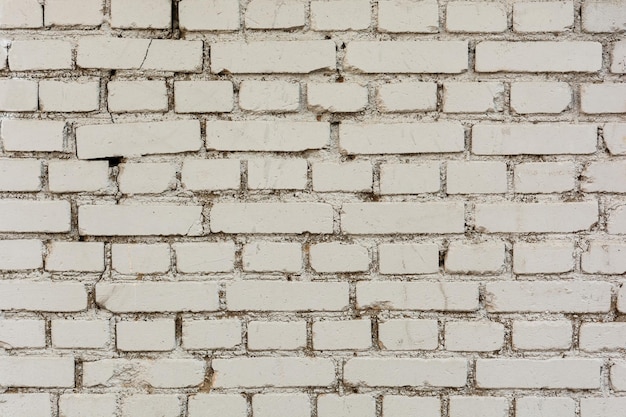Wall of old white brick with cement mortar
