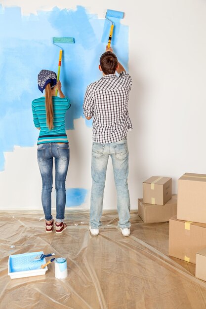 Wall painting home improvement home maintenance paint roller teamwork caucasian