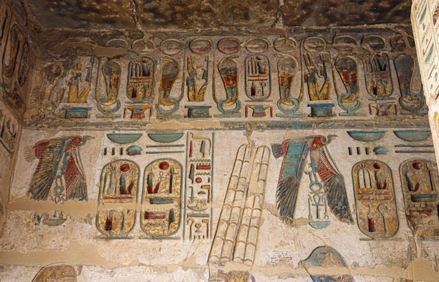 A wall painting of a winged figures with the word god on it.