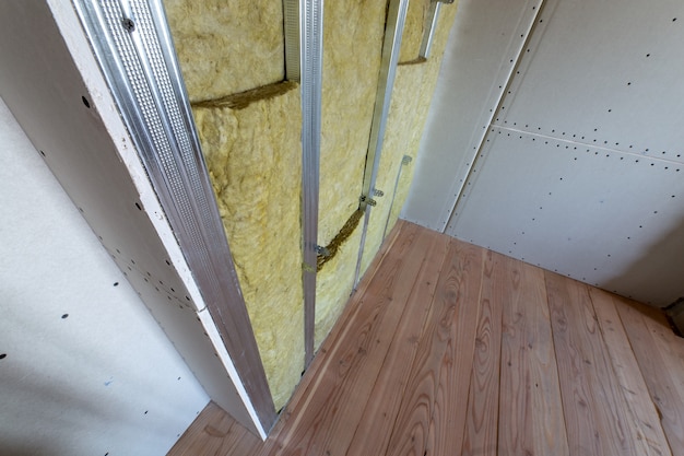 Wall of a room under renovation with mineral rock wool insulation