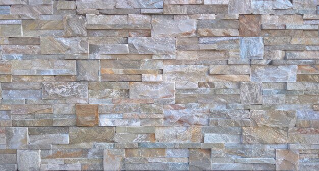 A wall of stacked stones with the word stone on it