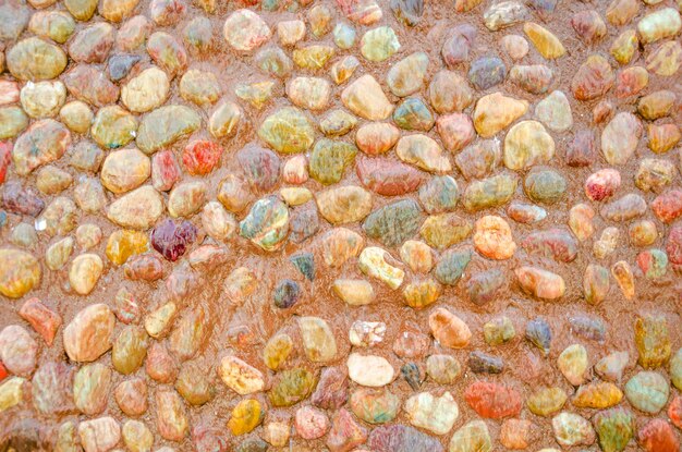 A wall of stones of different colors.