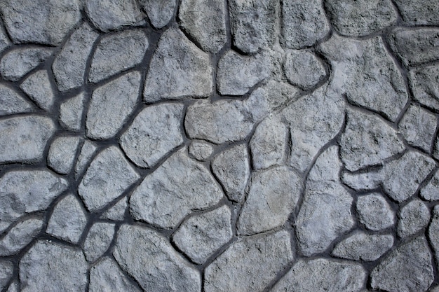 Wall of stones of different sizes and irregular shapes. Background. Texture.