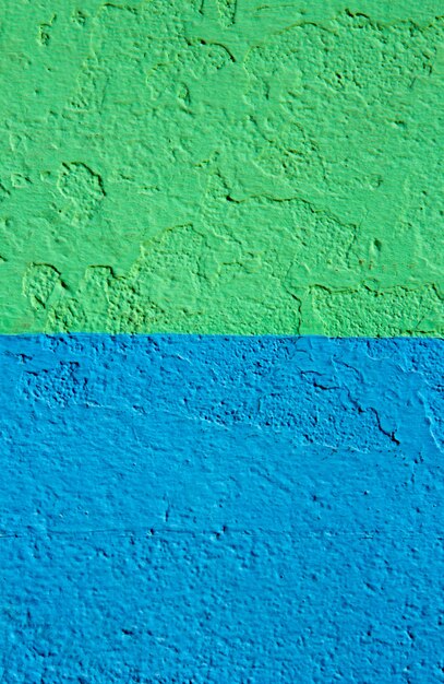 Wall texture with green and blue paint. Background.