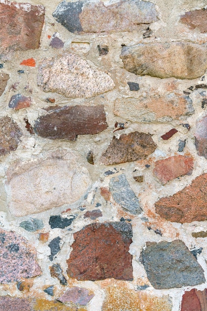 凹凸のある石の壁 ヴィンテージの建物の石造りの背景