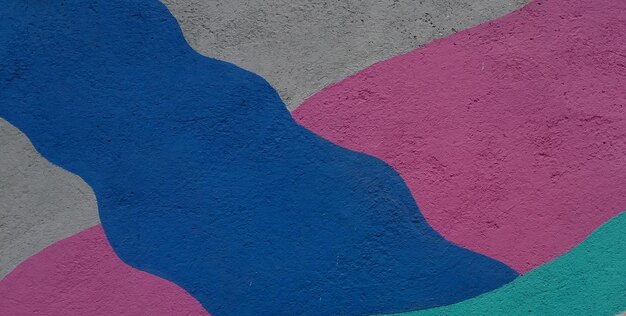 A wall with a blue and pink design