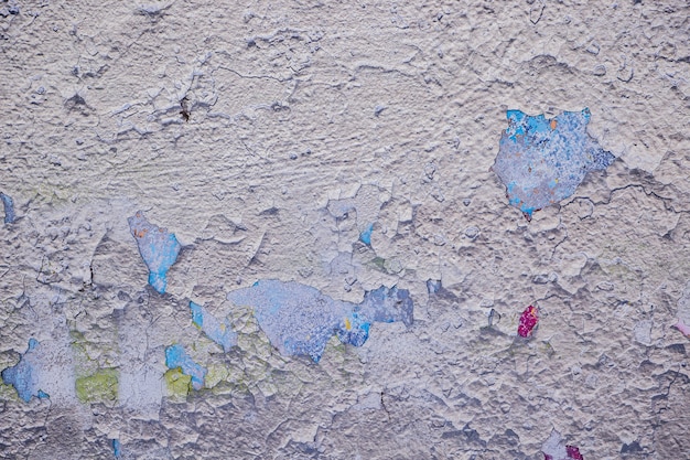 Wall with old peeling stucco close up