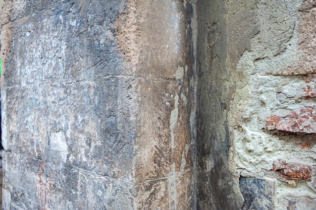 A wall with a stone and a sign that says'the word'on it '