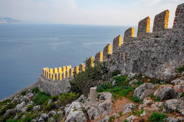 A wall with a view of the sea in the background