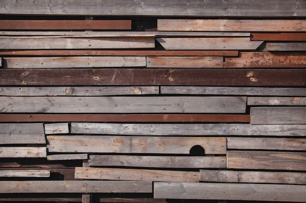 Wall of wooden boards with slits. 