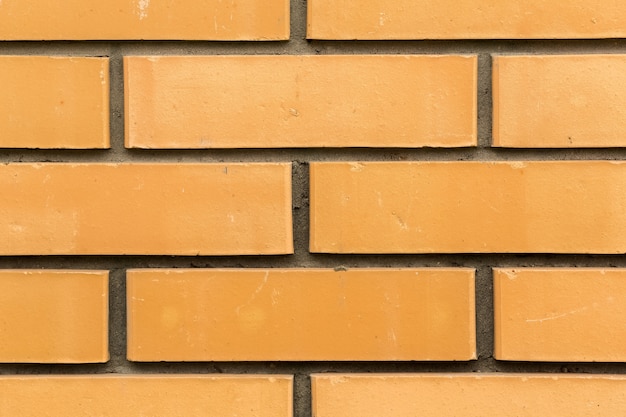 Wall of yellow bricks with cement seams