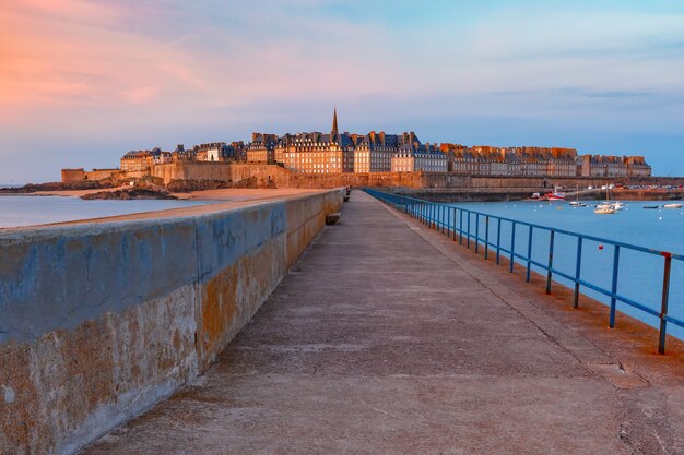 Walled city Saint-Malo with St Vincent Cathedral at sunset. Saint-Maol is famous port city of Privateers is known as city corsaire, Brittany, France