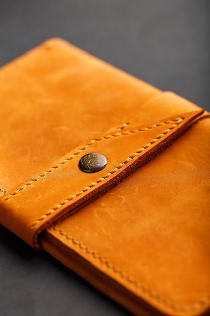 Wallet made of genuine brown nubuck leather on dark 