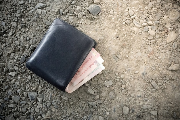 Wallet with money drop on the ground