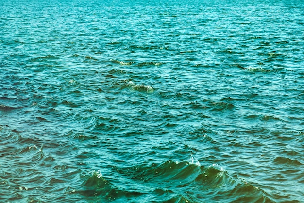 Wallpaper background of lapping river waves on water surface sea or ocean waves