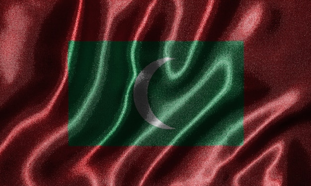 Sfondo di bandiera delle maldive e bandiera sventolante di tessuto