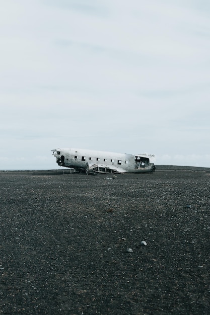 Wallpaper of the crashed wreck plane on Iceland with black sand beach during a sunny day