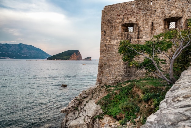 Walls of Citadel in Budva old town Island Sveti Nicola at background