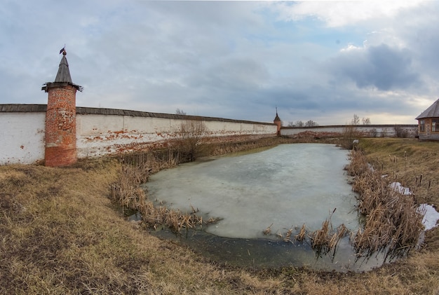 Walls and pond in Mikhailo Arkhangelsk monastery, courtyard of monastery