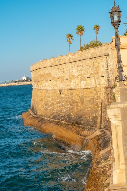 Walls and sea coast of the Baluarte de la Candelaria in the city of Cadiz Andalusia