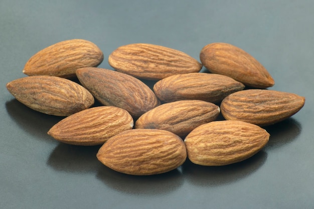 Walnut almonds handful close-up on a dark plate