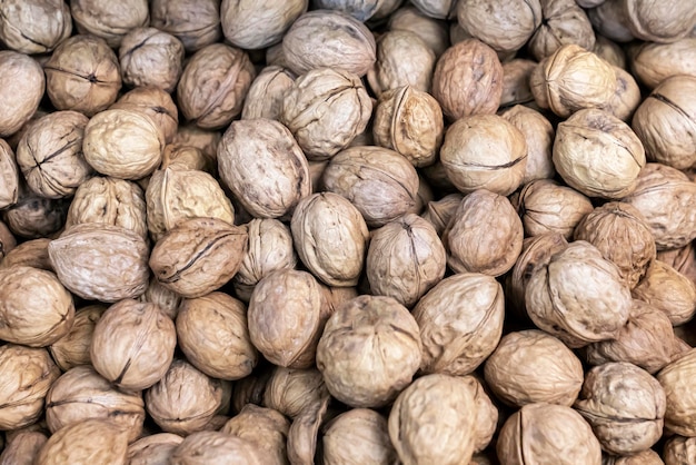 Walnut background fresh nuts on the market texture