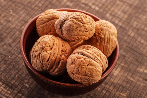 Walnut on black copy space Group of walnuts on a black background Nuts on a wooden plate