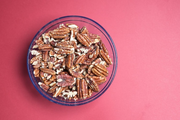 Walnut in a bowl on red background