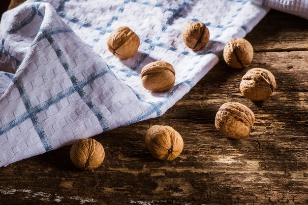 Walnut kernels and whole walnuts on an old wooden