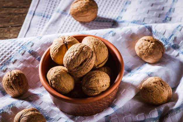 Walnut kernels and whole walnuts on an old wooden