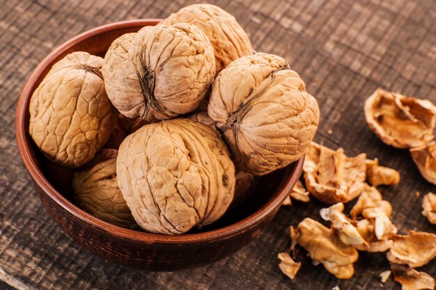 Walnut kernels and whole walnuts on old wooden