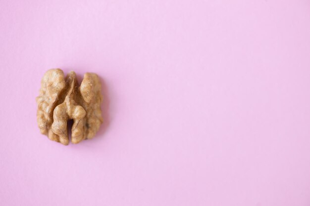 Walnut nut isolated on pink background