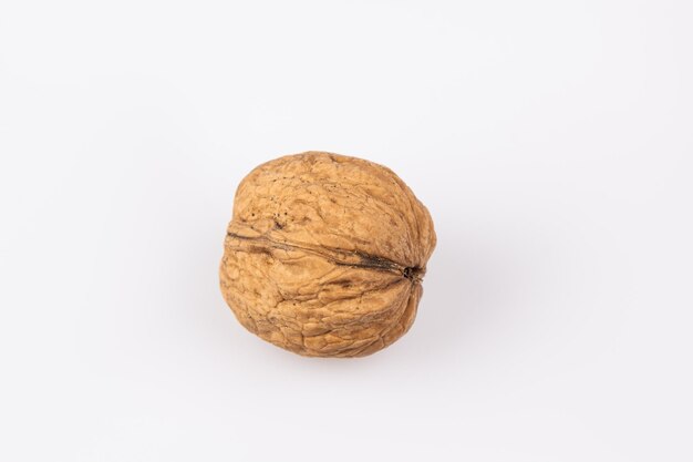 Walnut in shell isolated on white background Energy boost for the day The concept of proper nutrition Tasty breakfast