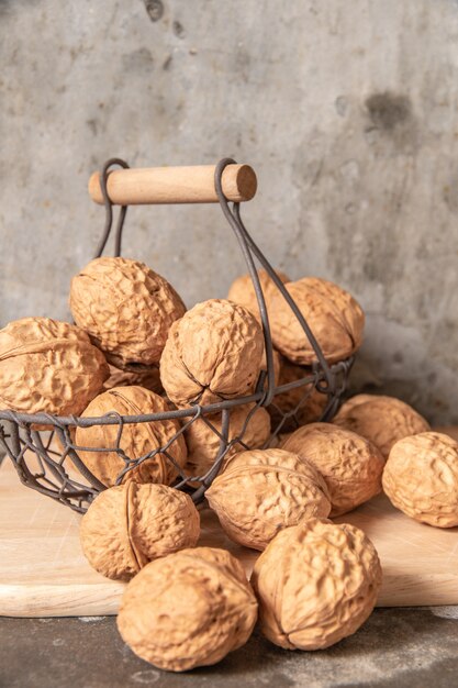 Walnut in steel basket on the cement table.