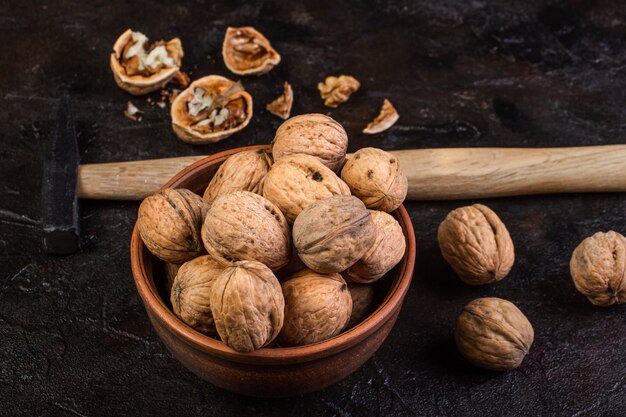 Walnut with hammer on concrete surface