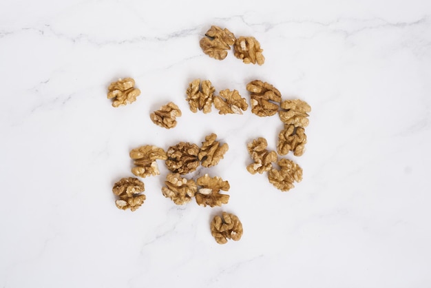 Walnuts are scattered on the marble table