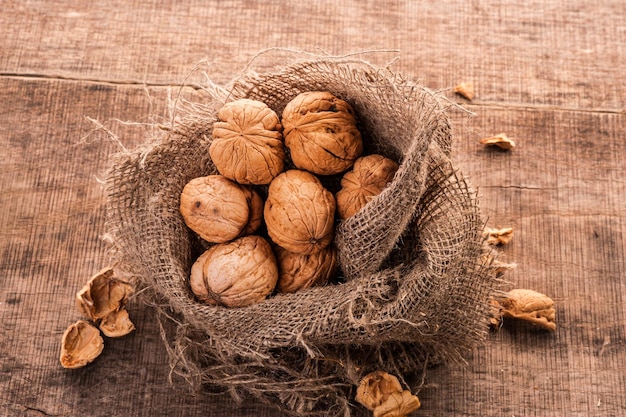 Walnuts in the bag on the old surface