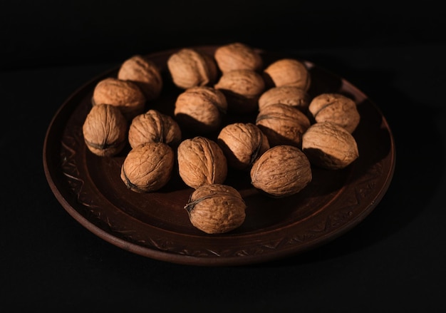 Walnuts in black key Nuts on a dark background