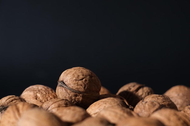 Walnuts in black key Nuts on a dark background