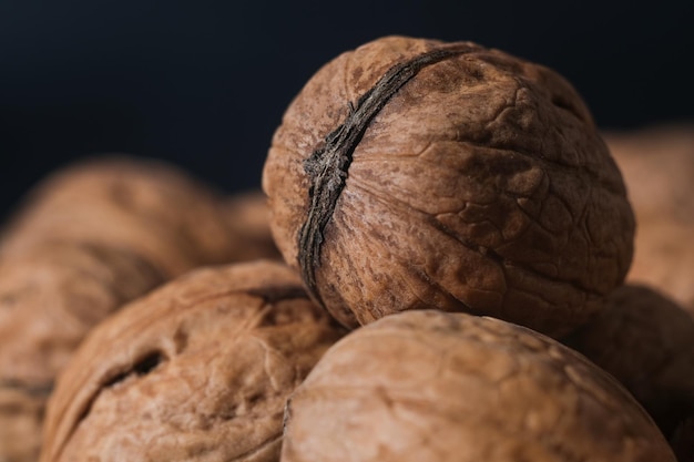 Walnuts in black key Nuts on a dark background