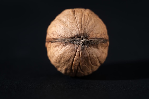 Walnuts in black key Nuts on a dark background