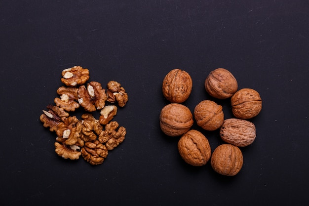 Walnuts on a black slate - healthy snack.