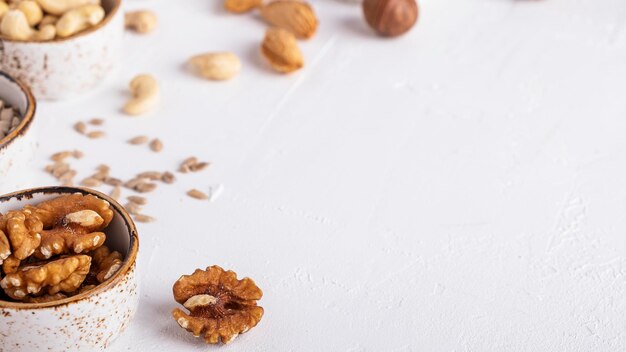 Walnuts in a bowl on a white top view