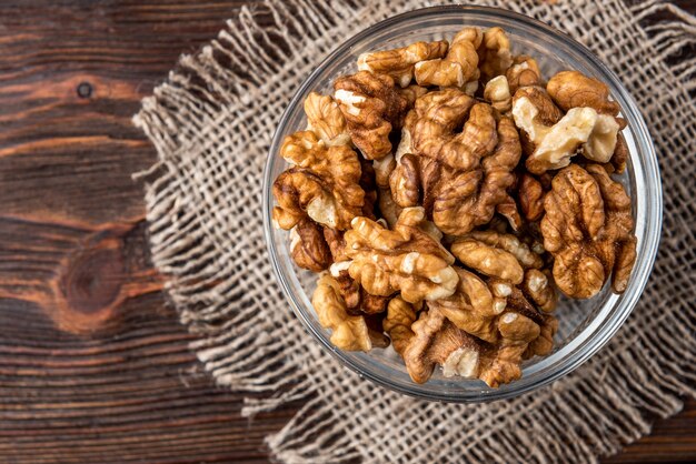 Walnuts in a bowl on a wooden table