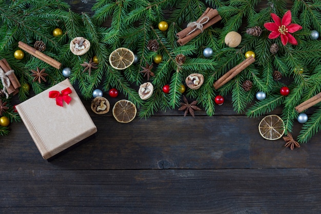 walnuts, cones and gold box with a gift with a red bow