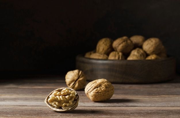 Walnuts on a dark brown wooden background