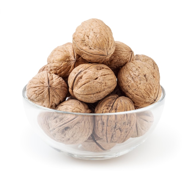 Walnuts in glass bowl isolated on white background with clipping path