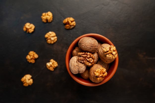 Walnuts. Kernels and whole nuts on a stone background