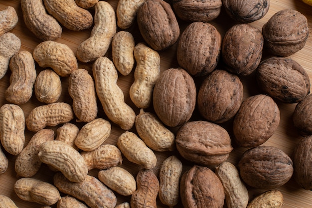 Walnuts and nuts on the wooden background