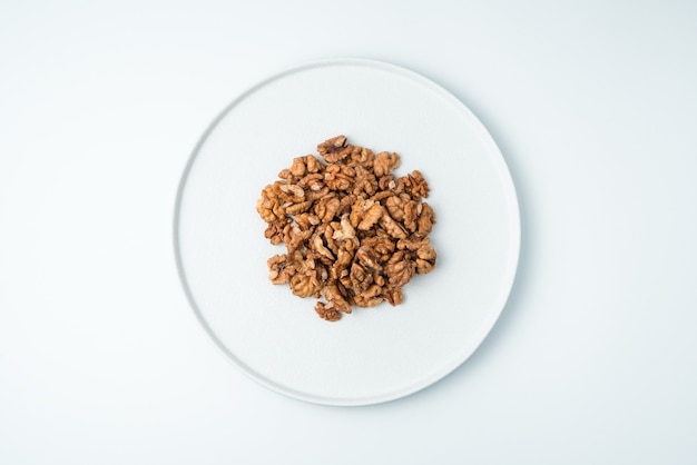 Walnuts peeled on a white surface